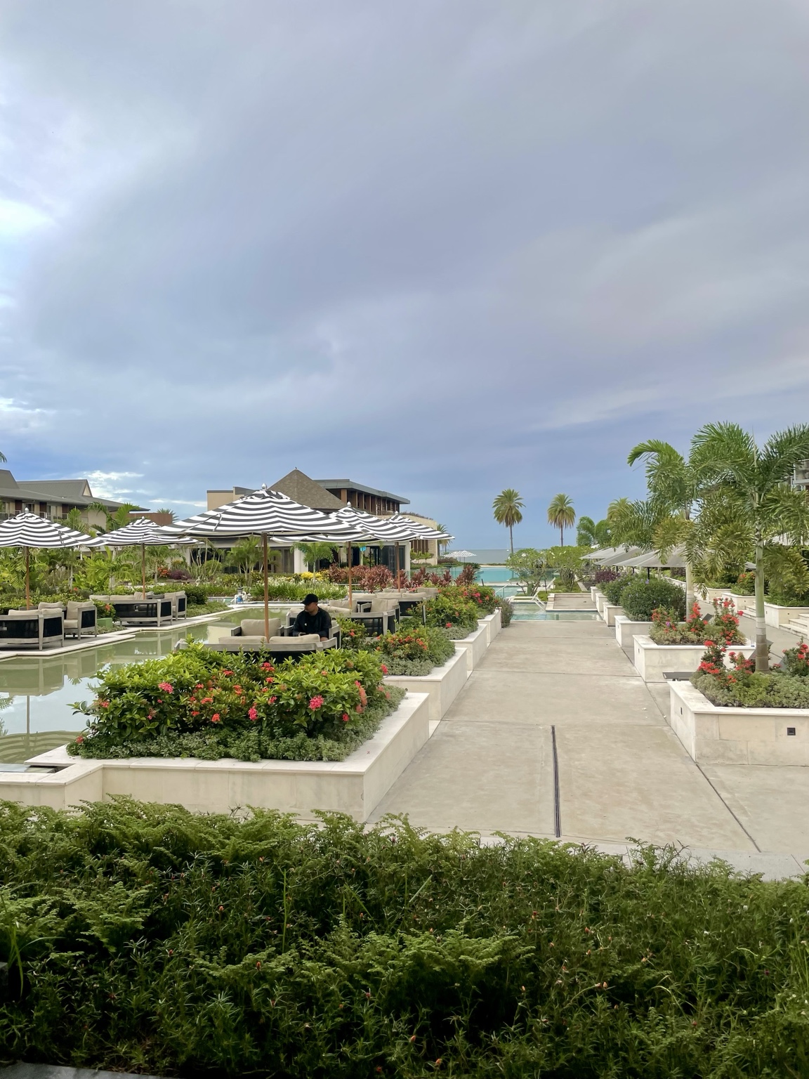 A tropical resort garden and pool facing the ocean in Fiji